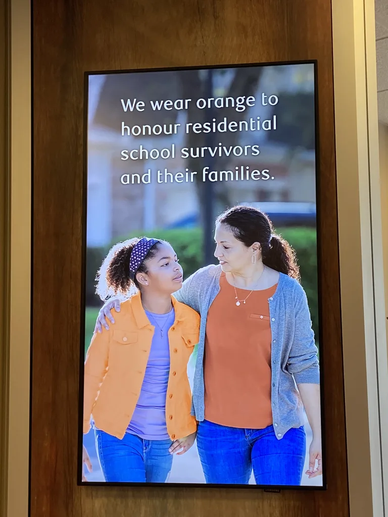 Poster featuring two individuals promoting Orange Shirt Day